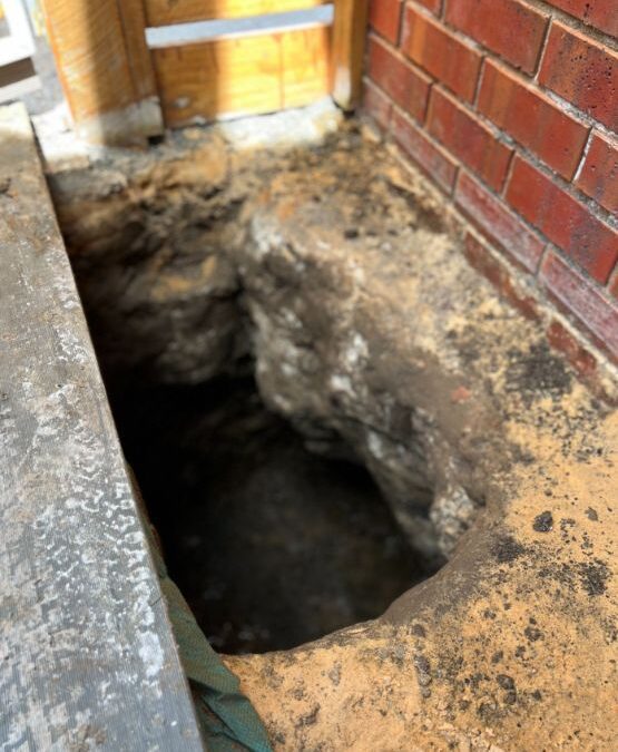 Our Underpinning Mount-Evelyn Service digging a hole to underpin a house